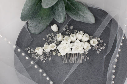 a bridal hair comb with flowers and pearls