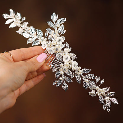 a woman is holding a bridal hair comb