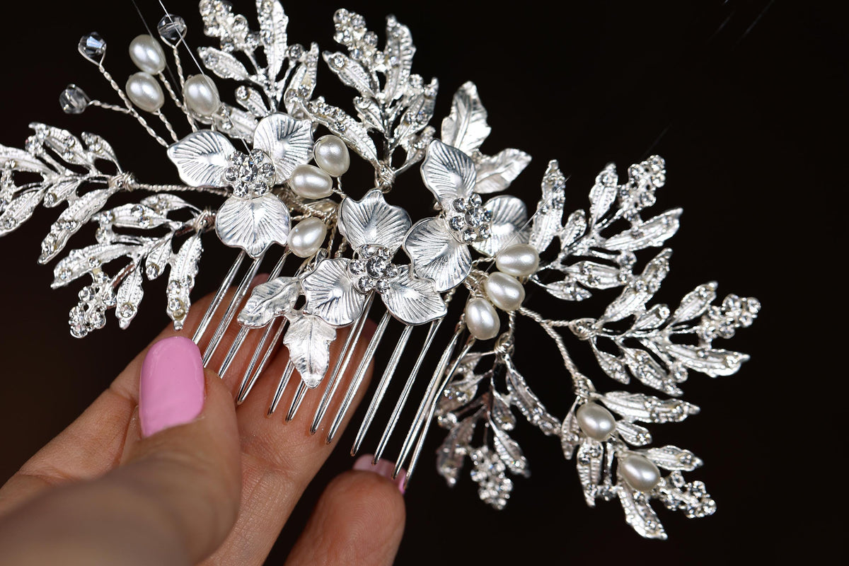 a close up of a person holding a hair comb