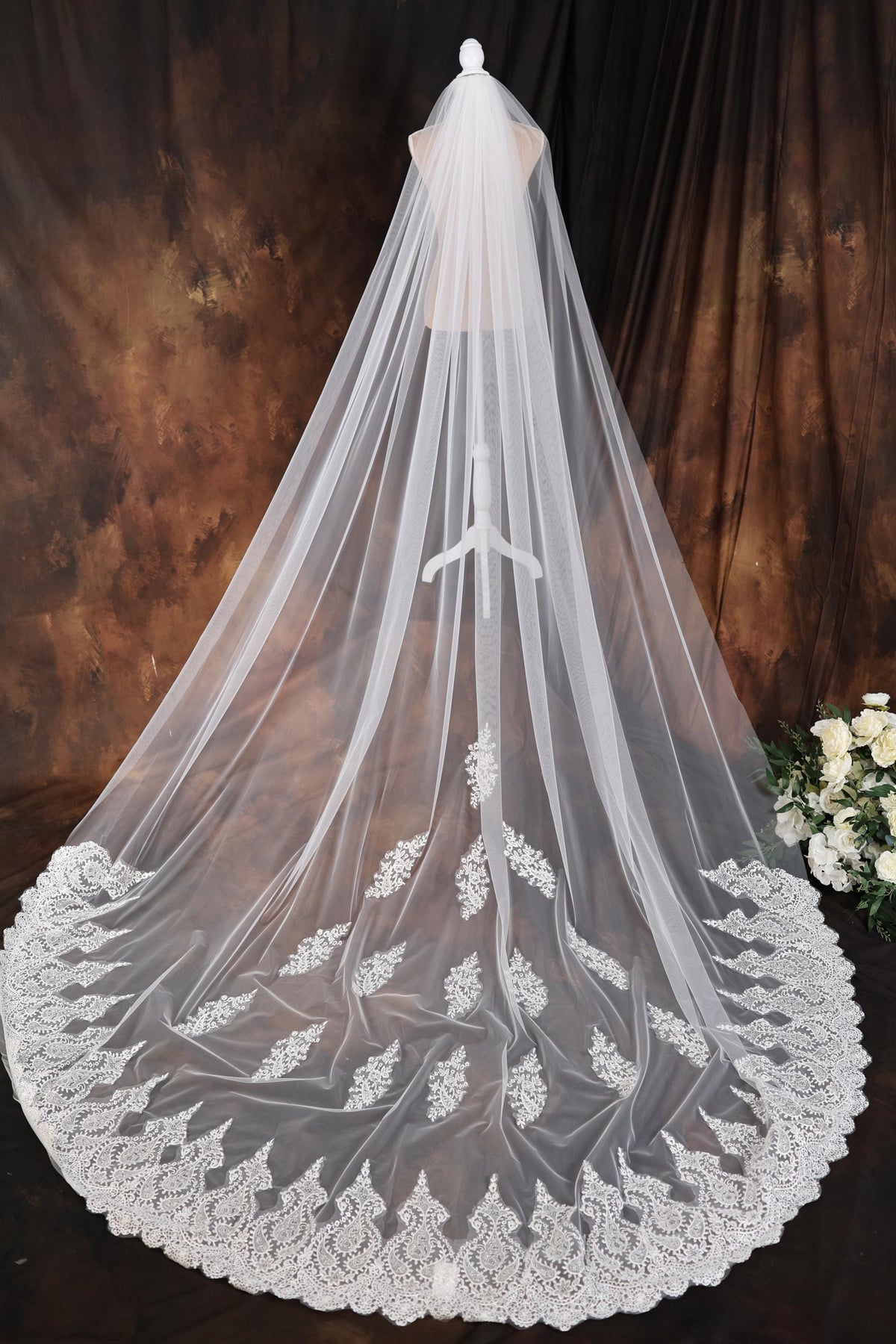 a white wedding veil with a lace edge