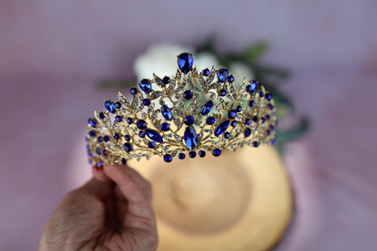 a person holding a piece of jewelry next to a flower