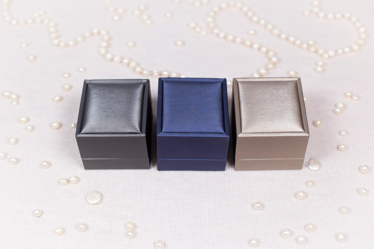 three small boxes sitting on top of a table