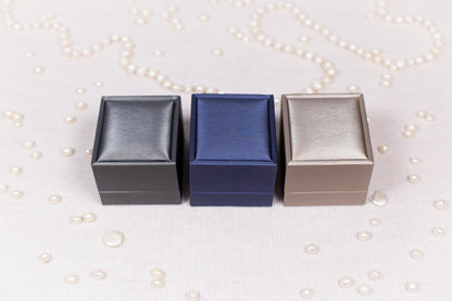 three small boxes sitting on top of a table