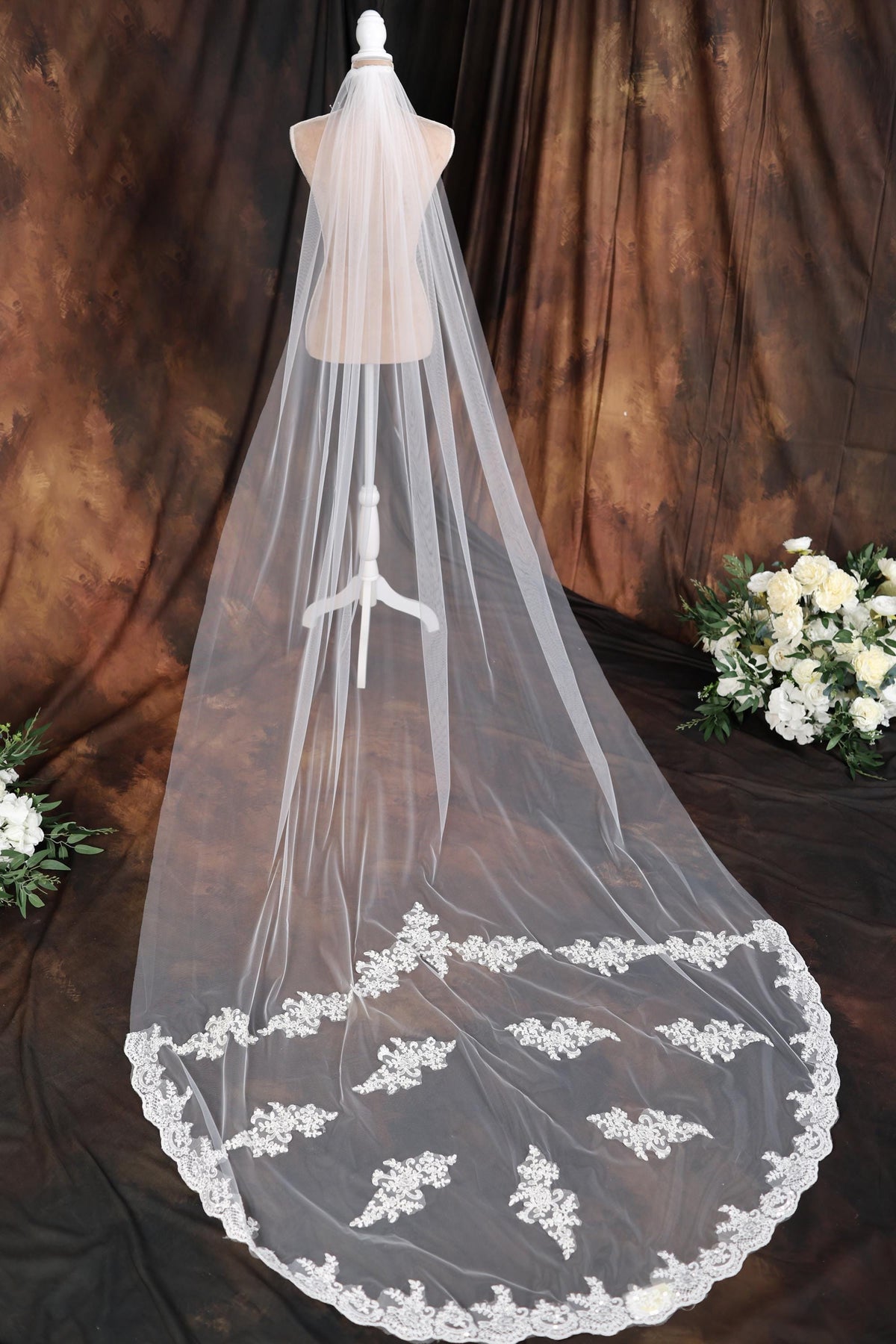 a wedding veil on a mannequin with flowers