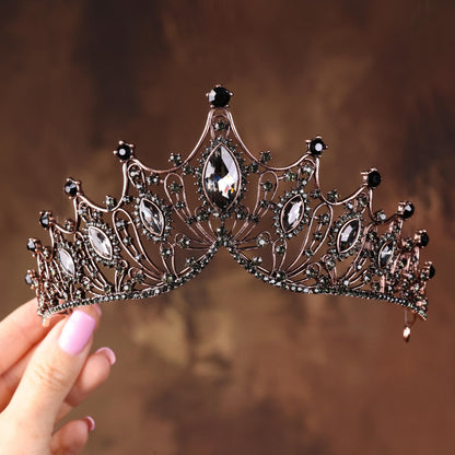 a close up of a person holding a tiara