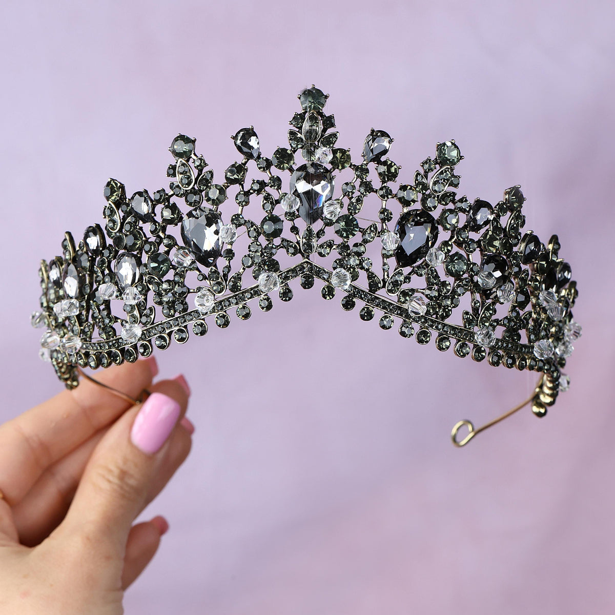 a woman holding a tiara in her hand