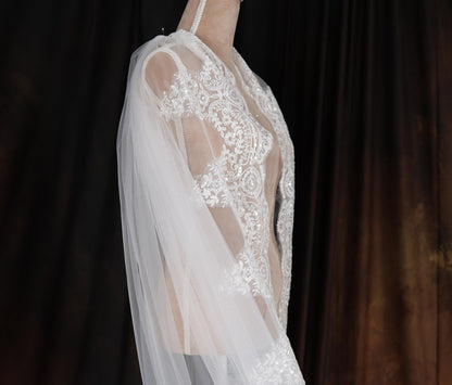 a woman wearing a wedding dress and veil