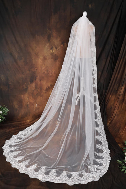a white wedding veil with a bow on top of it