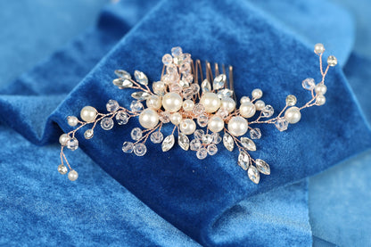 A decorative hair accessory with a floral design and clear gemstones is placed on a blue fabric background.