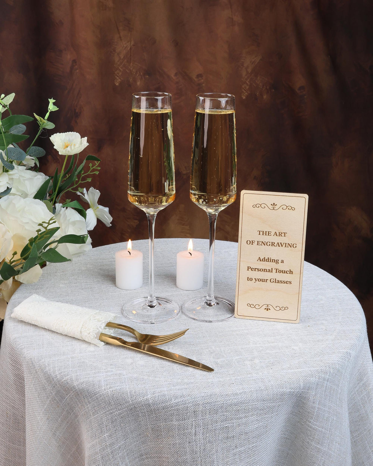 two glasses of wine on a table with a sign