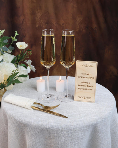 two glasses of wine on a table with a sign