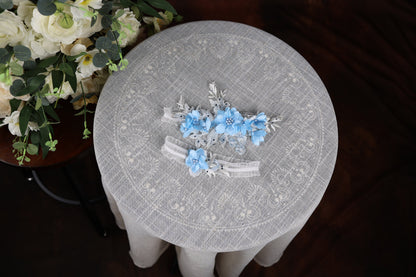 a table with flowers and a vase of flowers on it