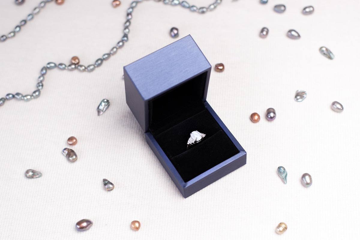 a ring sits inside of a box on a chain