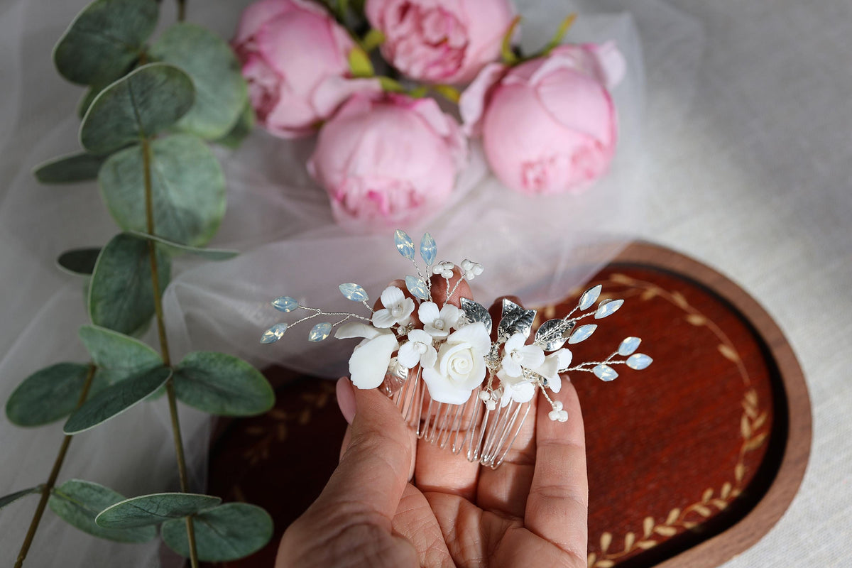 a person holding a comb with flowers on it