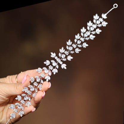 a woman holding a piece of jewelry in her hand