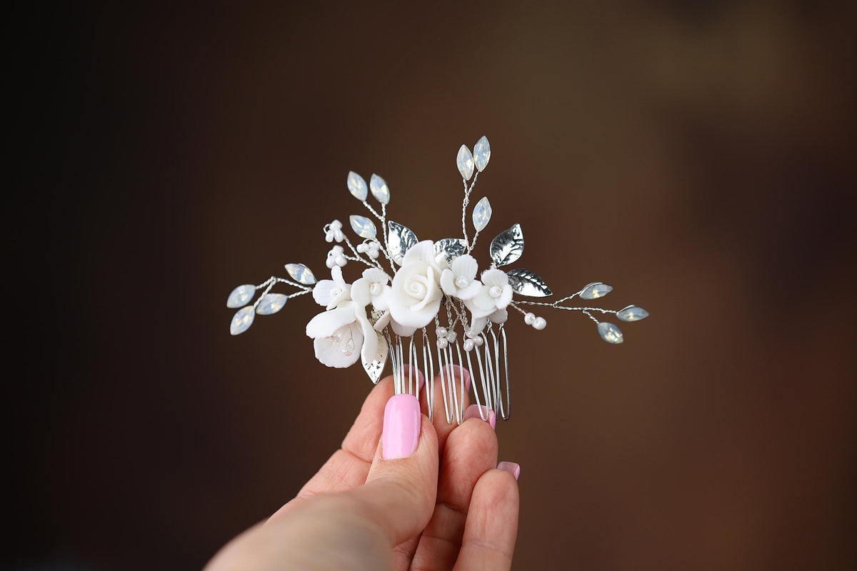 a woman holding a hair comb with flowers on it