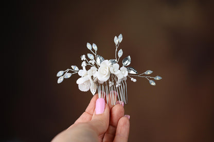 a woman holding a hair comb with flowers on it