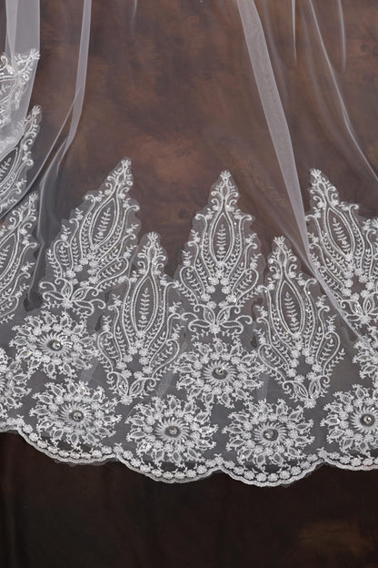 a close up of a white lace on a brown background