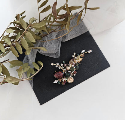 a flower brooch sitting on top of a black card