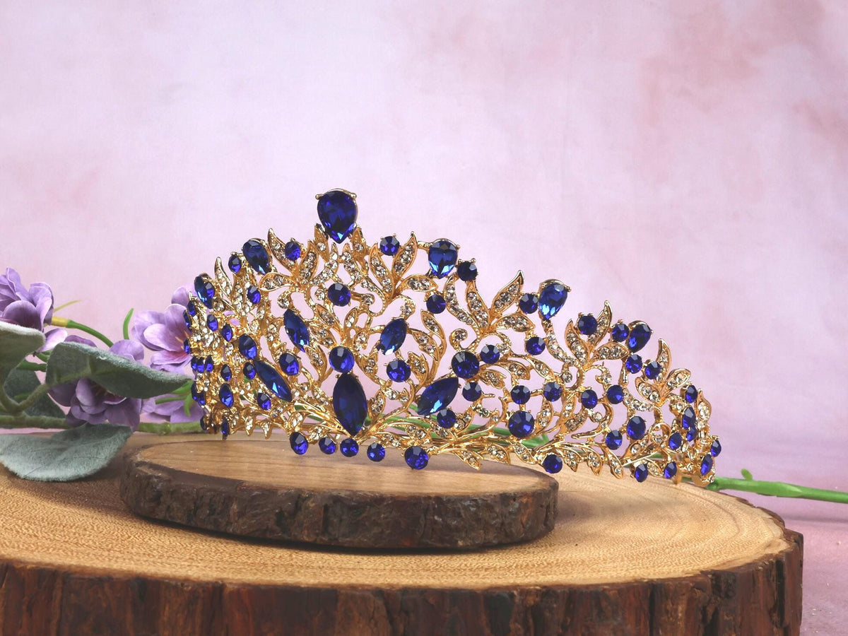 a blue tiara sitting on top of a tree stump