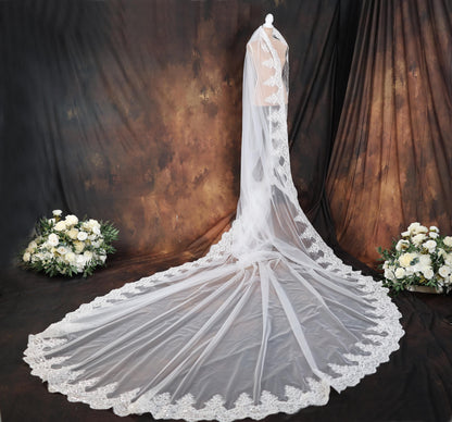a bridal gown with a veil and flowers