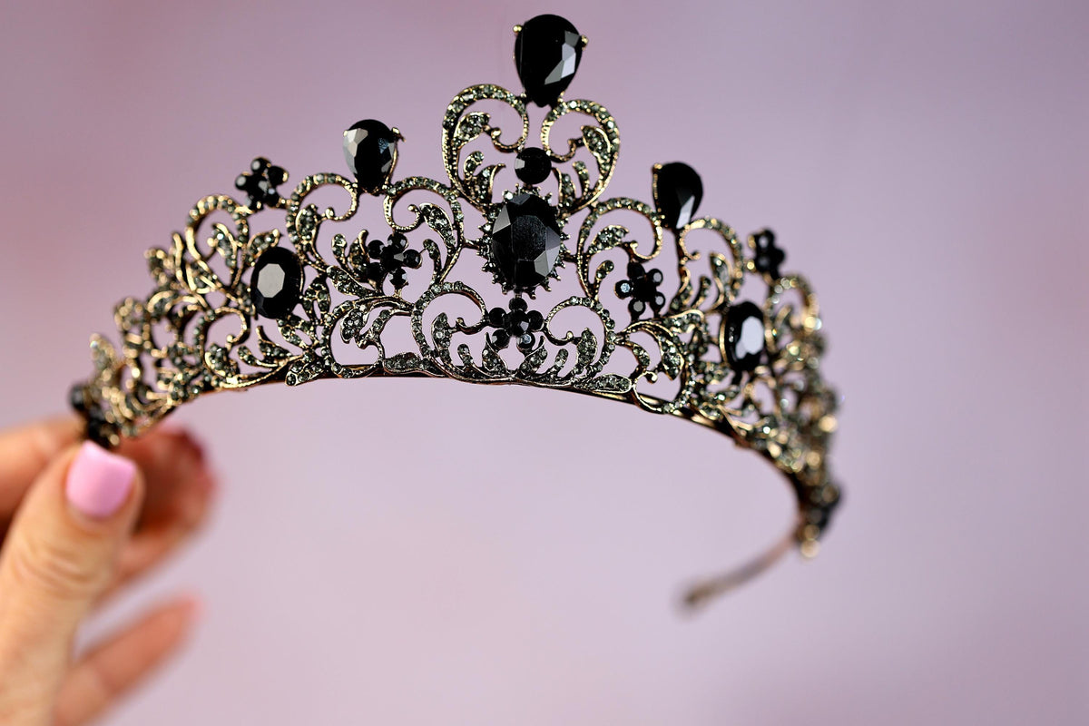 a close up of a tiara on a person's hand