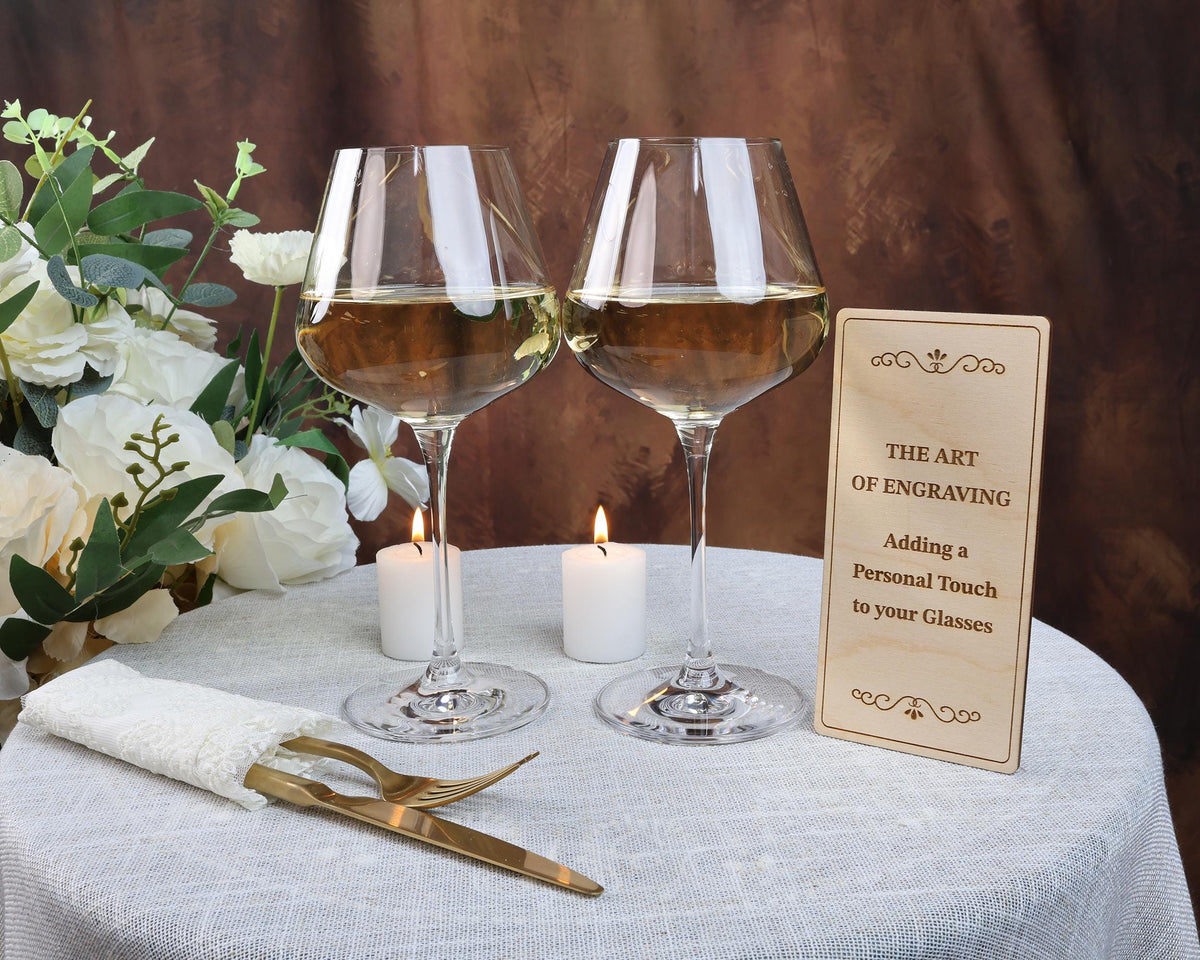 two glasses of wine sitting on top of a table