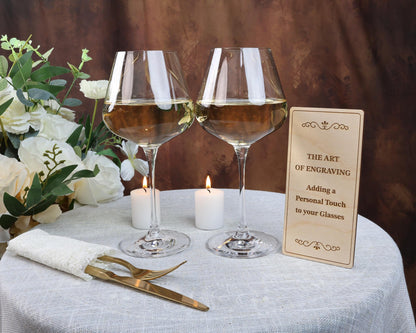 two glasses of wine sitting on top of a table