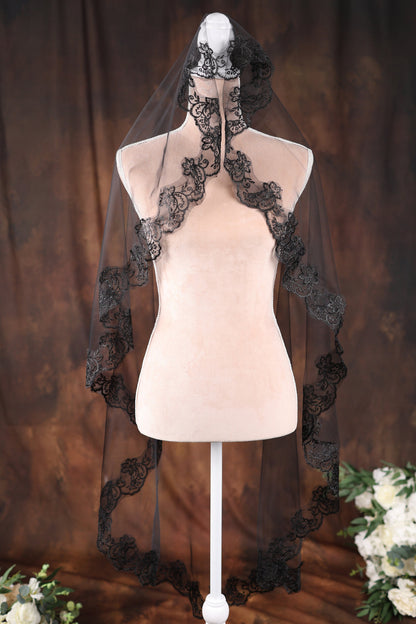 a white mannequin with a black veil on top of it