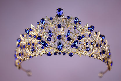 a blue and gold tiara on a purple background