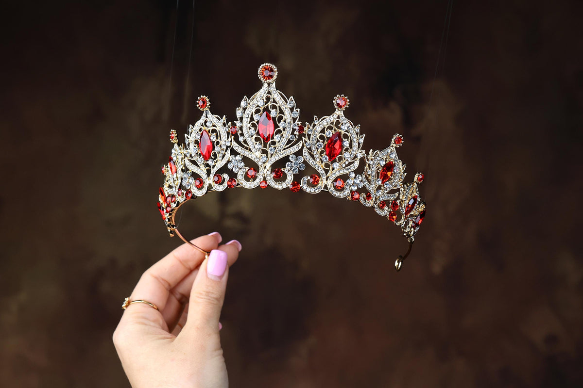 a woman holding a tiara in her hand