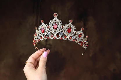 a woman holding a tiara in her hand