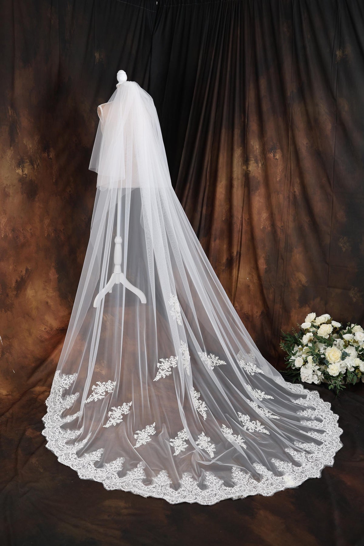 a wedding veil on a mannequin with flowers