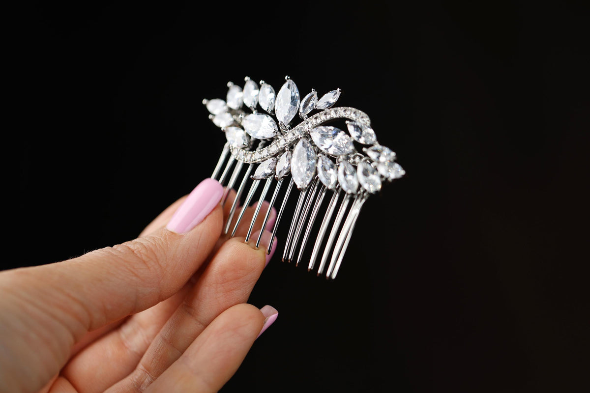 a close up of a person holding a hair comb
