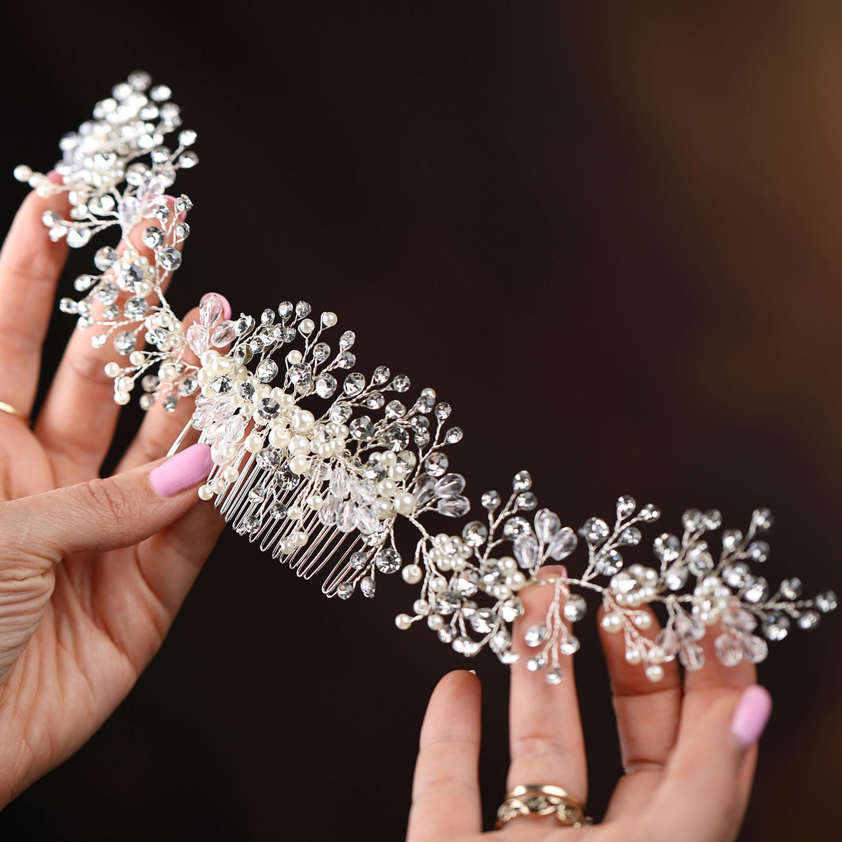a close up of a person holding a hair comb
