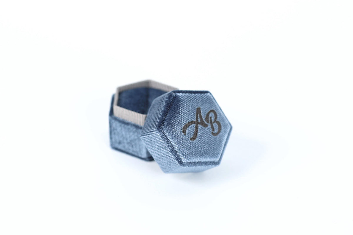 A blue hexagonal box with a logo on it, placed on a white background.