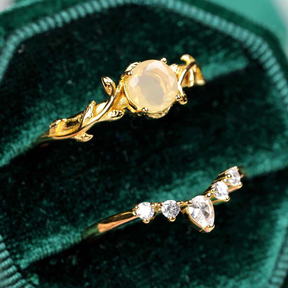 a couple of rings sitting on top of a velvet bag
