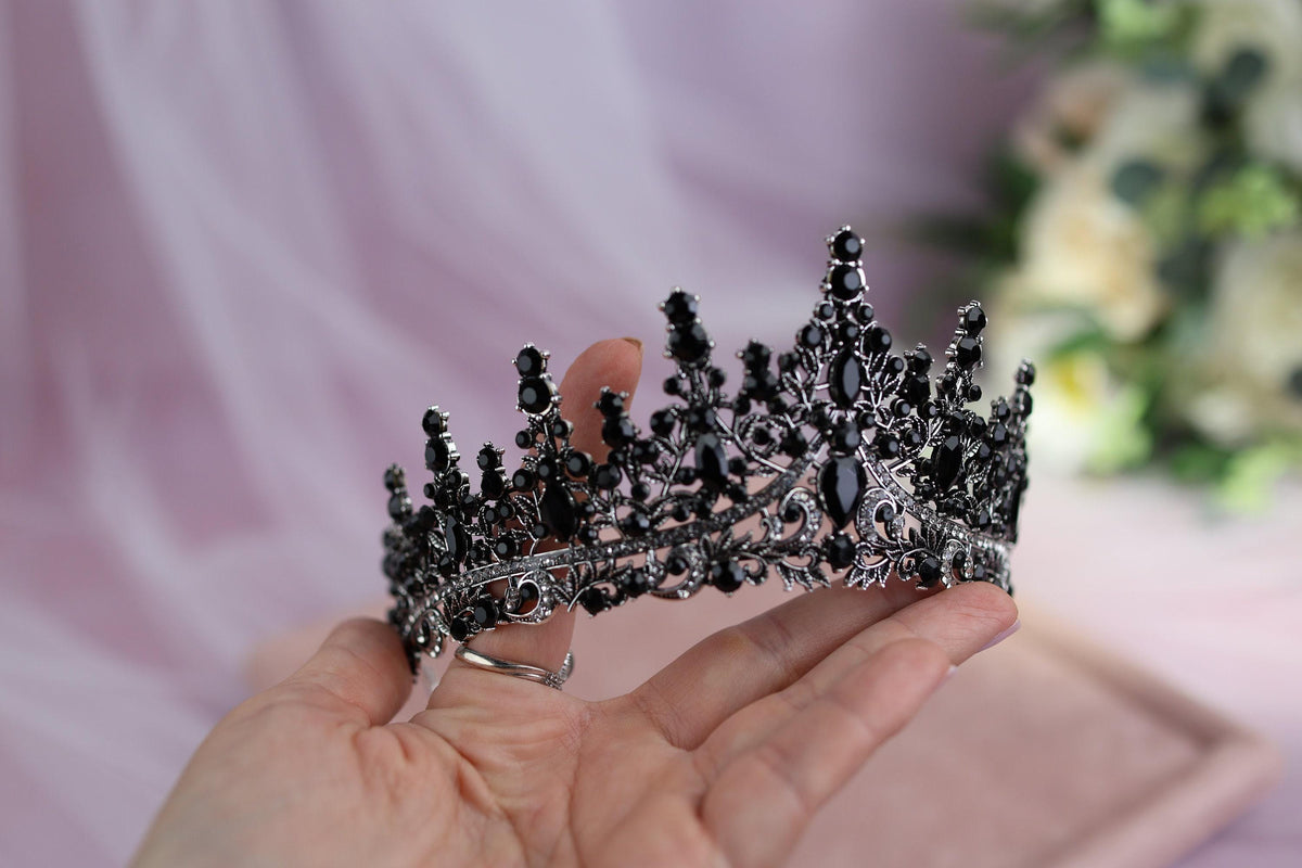 a woman holding a tiara in her hand