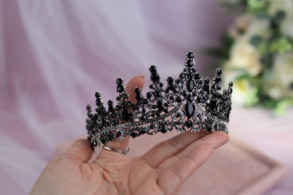a woman holding a tiara in her hand