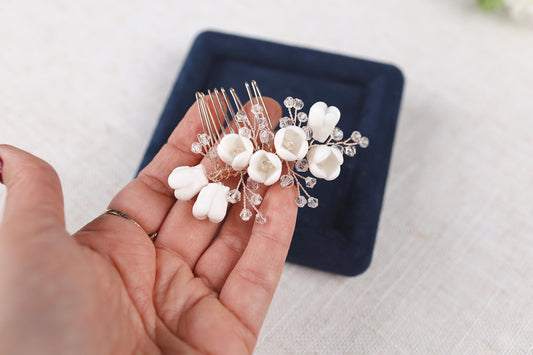 a person holding a comb with flowers on it
