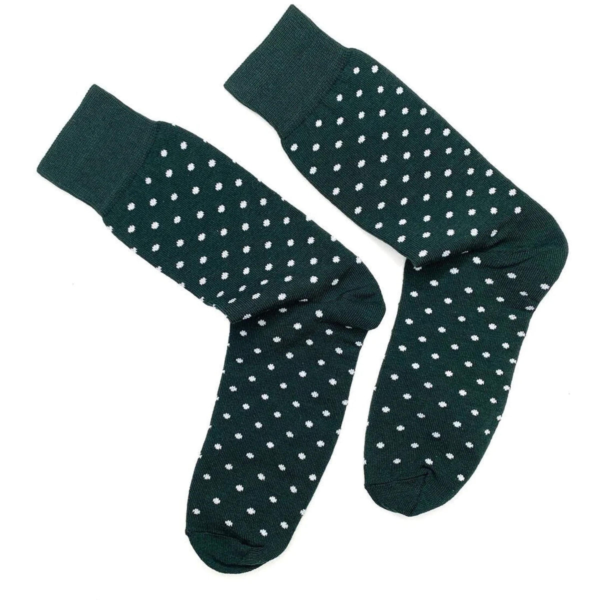 a pair of dark green socks with white polka dots, arranged side by side.