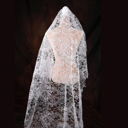 a mannequin is covered with a white veil