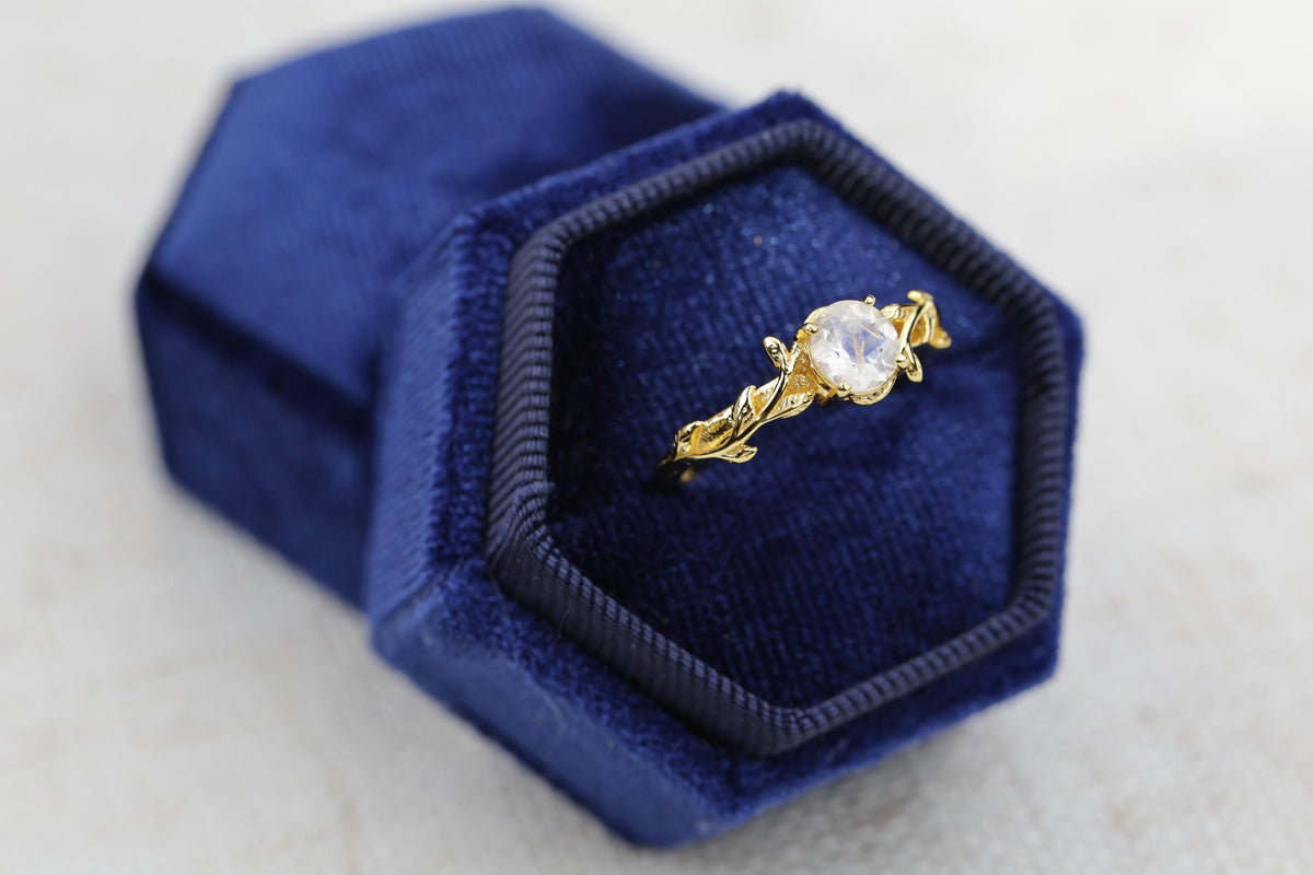 a diamond ring in a blue velvet box