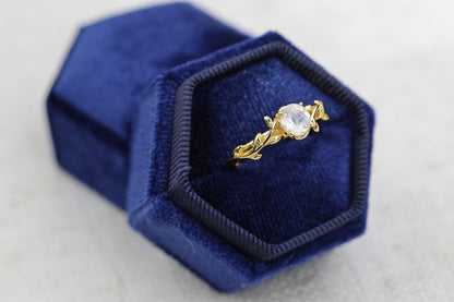 a diamond ring in a blue velvet box