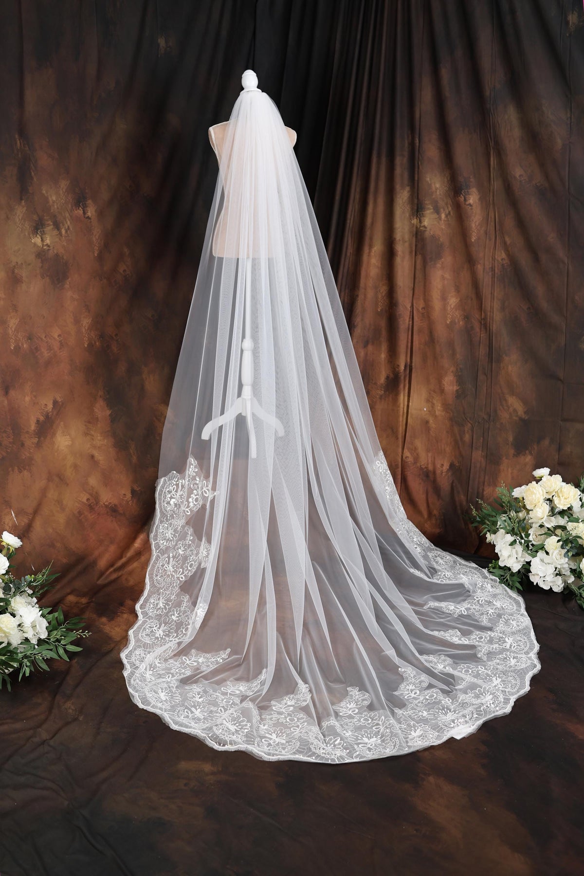a wedding veil on a mannequin in front of a backdrop