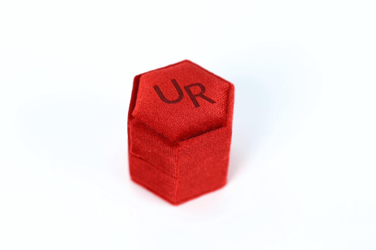 A red hexagonal box with the letters "UR" printed on it.