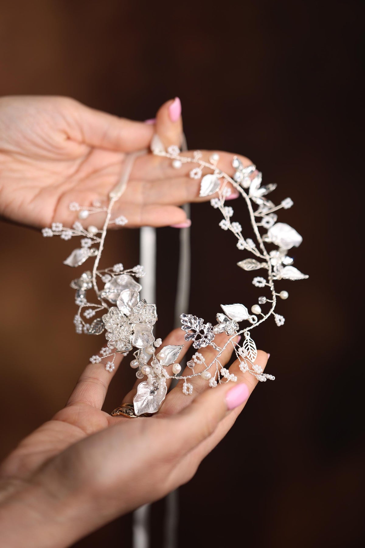 a close up of a person holding a piece of jewelry