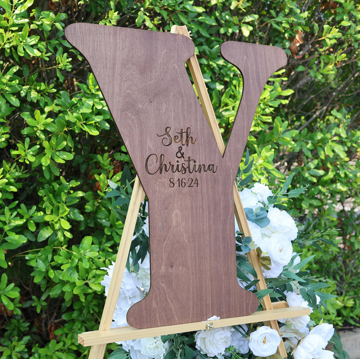 a wooden sign with a wedding date on it