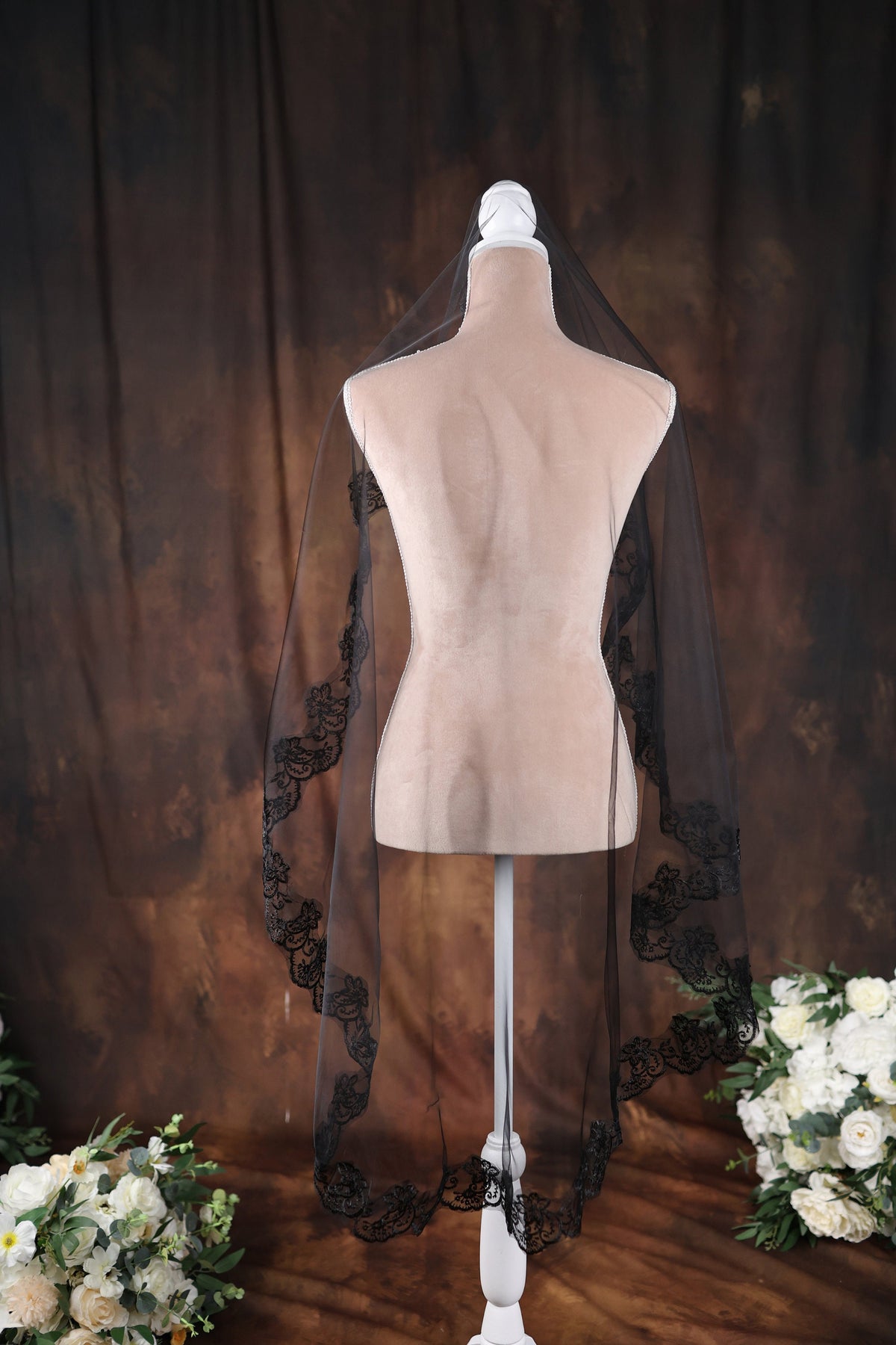 a mannequin with a black veil on top of it