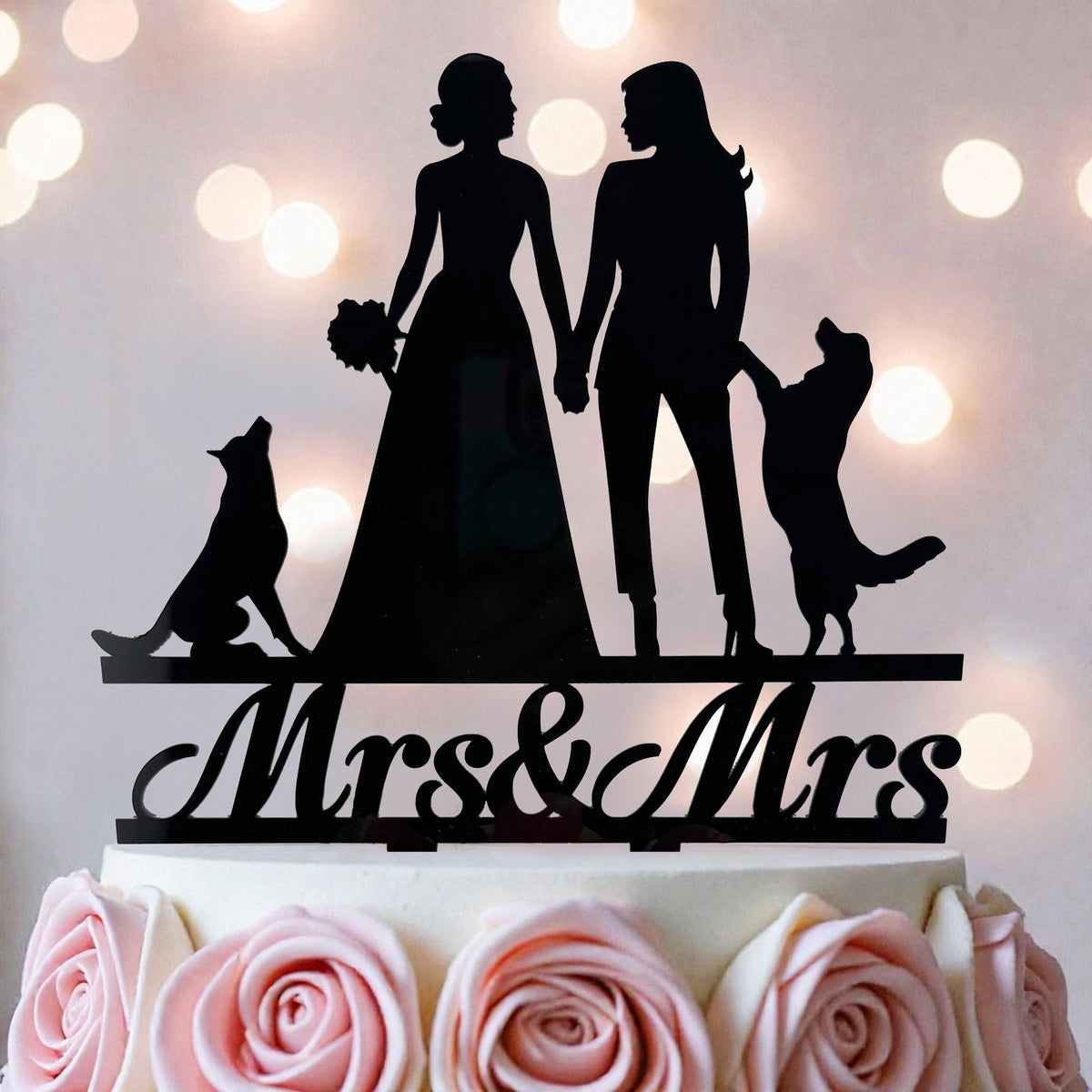A silhouette of a bride and groom holding hands, with a dog and a rose on a wedding cake topper.
